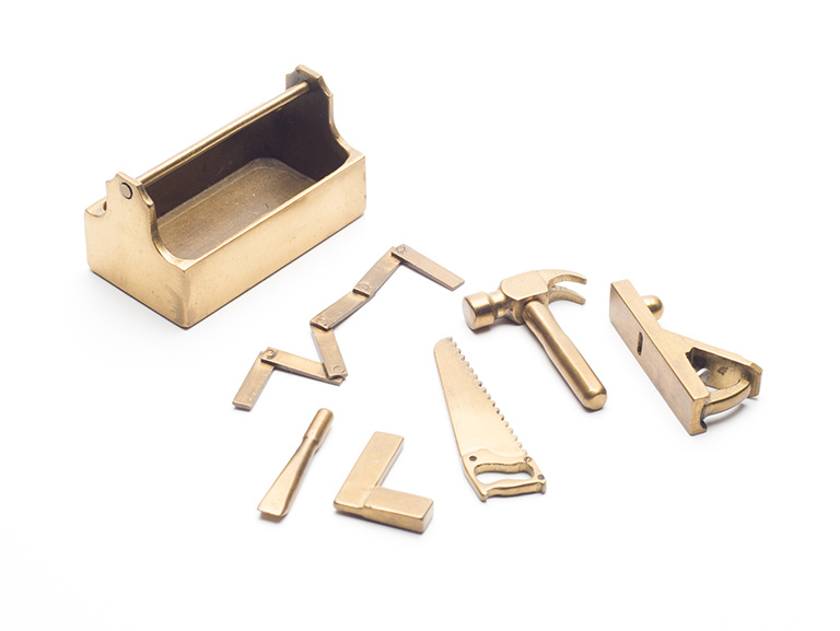Miniature brass carpenter's toolbox and various tools