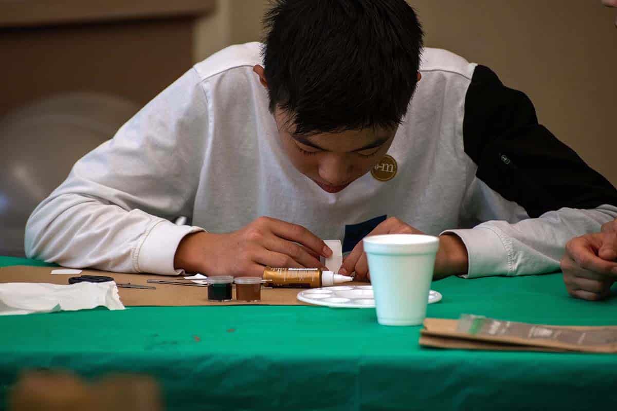 Boy working on a miniature
